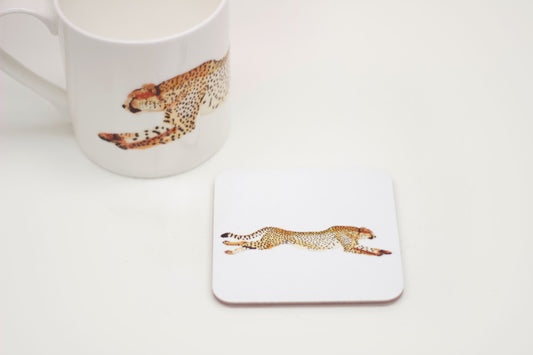 A white square coaster with a cork backing, featuring an illustration of a cheetah in a light and earthy style.