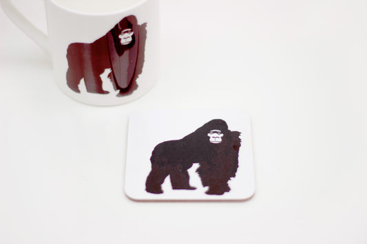 A coaster with an illustration of a gorilla, part of the Africa Collection. The coaster is white with a black gorilla on it.