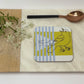 Coaster with a design on a marble surface with a wooden board and spoon.