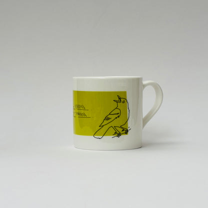 White mug with a green accent featuring a bird illustration on a white background
