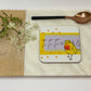 Coaster with a bird design on a wooden board with a white background