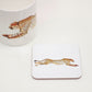 A white square coaster with a cork backing, featuring an illustration of a cheetah in a light and earthy style.