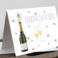 A greetings card with a 'CONGRATULATIONS' text, featuring an illustration of a champagne bottle and glass, and decorated with multicolored confetti and decorative lines.