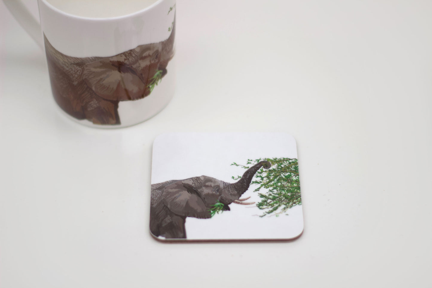 A coaster featuring an illustration of an elephant with leaves on its trunk, part of the Africa collection.