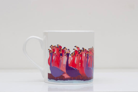 A white bone china mug with a printed flamboyance of flamingos design in red and purple colors.
