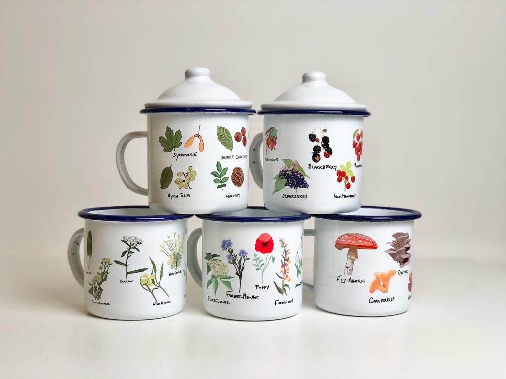 A collection of enamel mugs with various illustrations of plants and fungi, each with a blue rim and lid, displayed against a white background.
