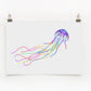 A digital print of a colorful jellyfish on a white background, displayed on a wall.