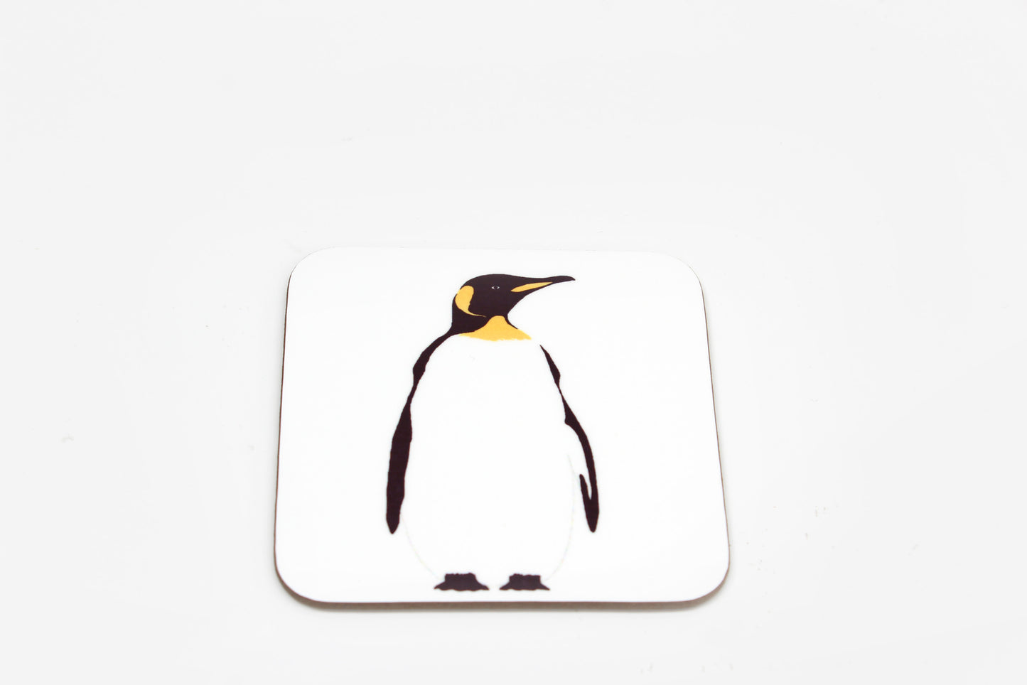 A square white coaster with a central penguin design.