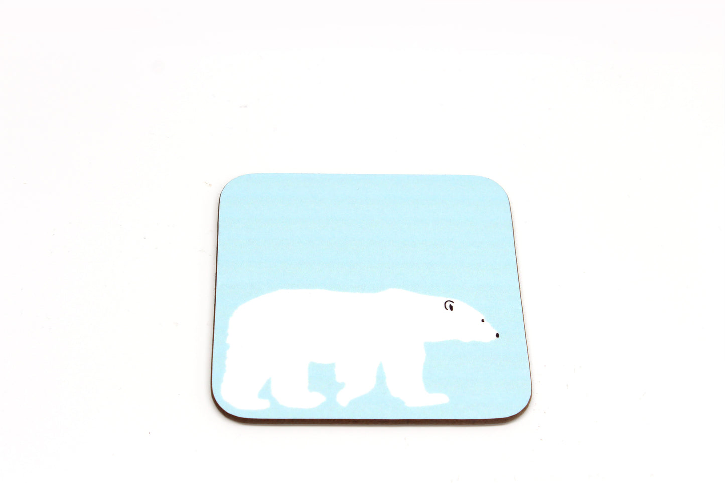 A square-shaped, blue hardboard coaster with a polar bear design.