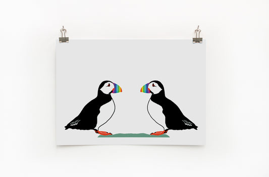A digital print featuring two puffins with colorful rainbow beaks. The background is plain white.