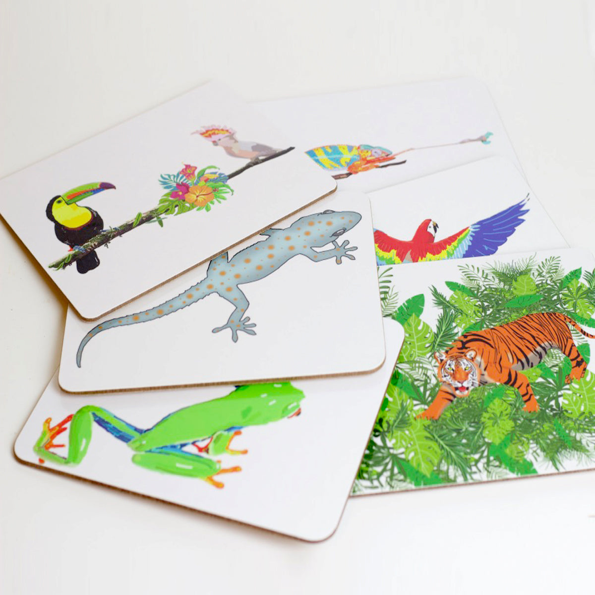 A set of placemats with various jungle animals depicted on them, including birds and reptiles.