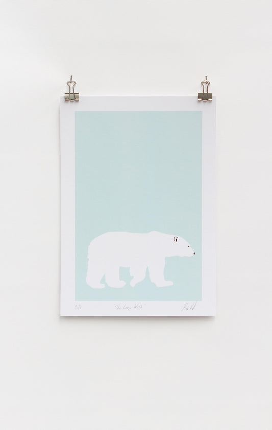 A digital print featuring a lone polar bear on a light blue background, mounted on a wall.