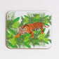 A square coaster with a hand-drawn tiger design, jungle background, and green foliage.