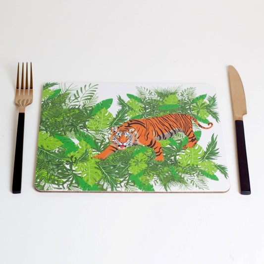 A placemat with a jungle theme featuring a drawing of a tiger among foliage, displayed with a fork and knife on either side.