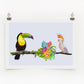 A digital print featuring a colorful illustration of a toucan and a cockatoo with surrounding tropical flowers, displayed on a wall.