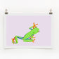 Digital print of a green and orange tree frog on a purple background, framed and hanging on a wall.