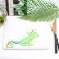A colorful placemat featuring a drawing of a tree frog on a white background.