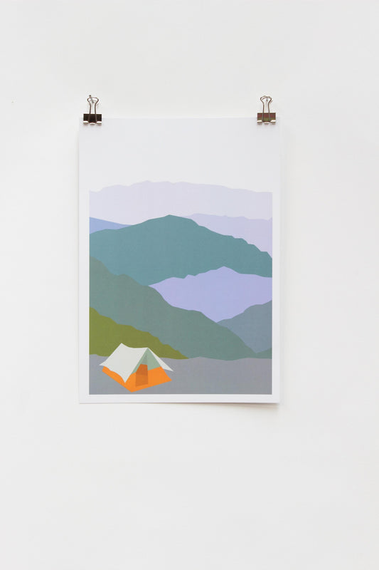 A digital print of a tent in a mountainous landscape, framed and displayed on a white wall using two clip hinges.