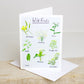 A greetings card with illustrations of various wild foods, with the title 'Wild Foods' at the top. The card is shown with a white envelope, placed on a wooden surface.